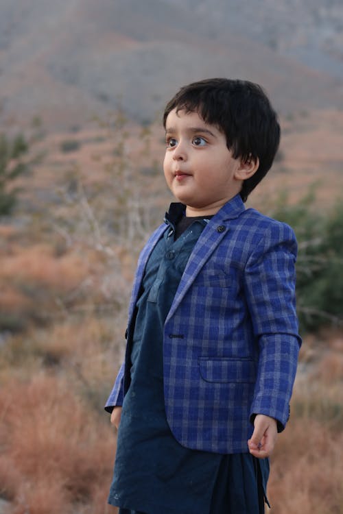 A Boy Wearing a Checkered Blue Coat