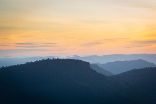 Free A breathtaking view of a serene mountain landscape during twilight in Thailand, showcasing the golden hue of the sky. Stock Photo