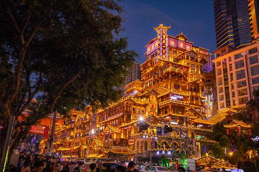 Stunning view of the illuminated Hongyadong complex in Chongqing at nighttime, showcasing vibrant urban architecture.