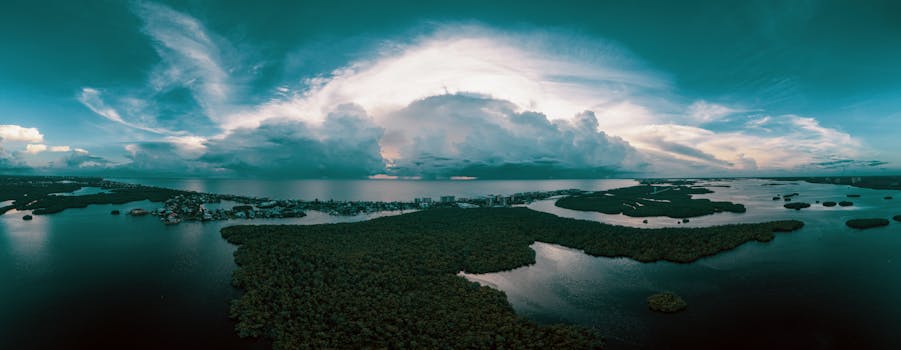 Stunning aerial view of coastal Bonita Springs with dramatic cloud formations and waterways.