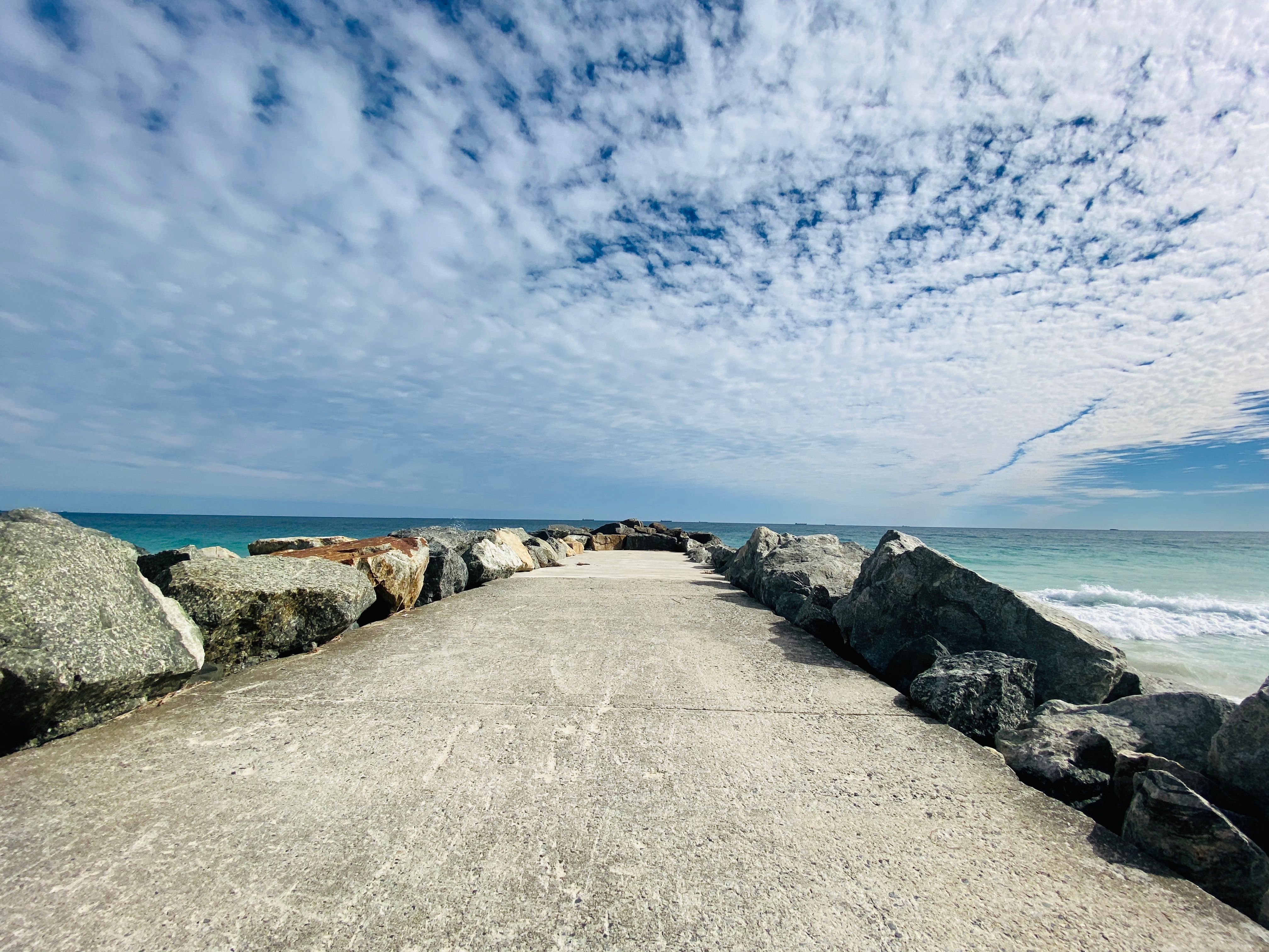 A Concrete Dock Near the Ocean Under the Cloudy Sky · Free Stock Photo