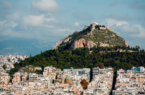 Free Aerial View of  City near Green and Brown Mountain Stock Photo