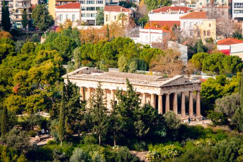 Free Aerial view of the ancient Temple of Hephaestus surrounded by greenery in Athens, Greece. Stock Photo
