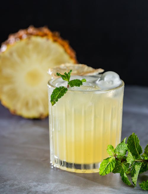 Glass of Pineapple Juice With Ice Cubes and Mint