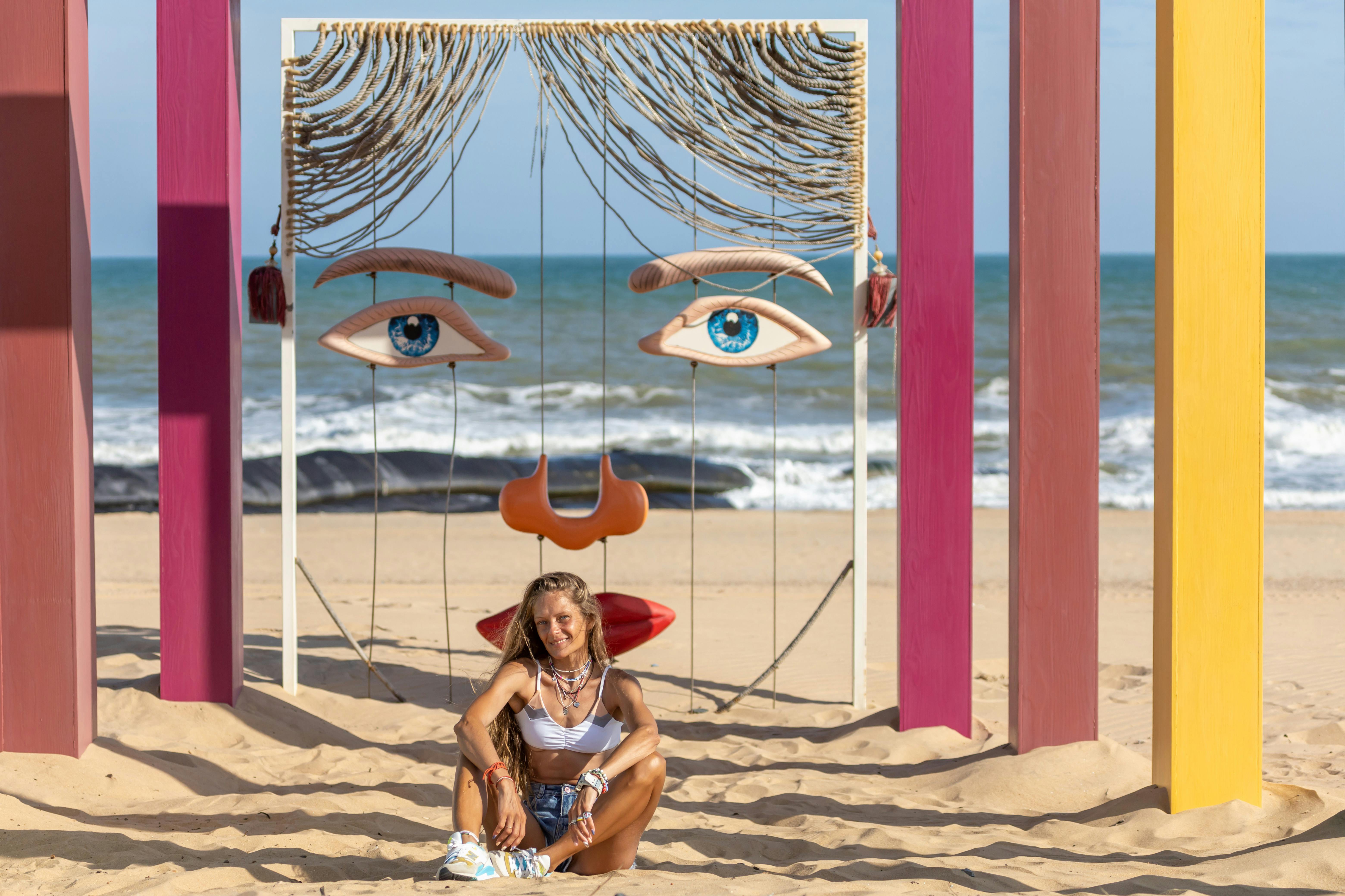 women sitting on sandy beach