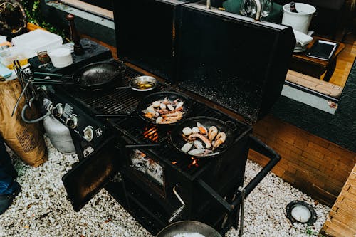 View of Seafood on Frying Pans on a Stove 