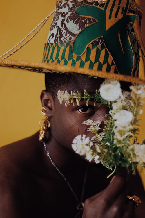 Portrait of a Man Wearing a Top Hat Holding a Bunch of Blooming Flowers