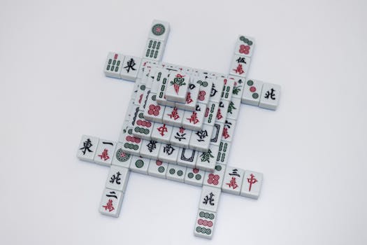 Intricately stacked mahjong tiles on a white background, showcasing traditional design.