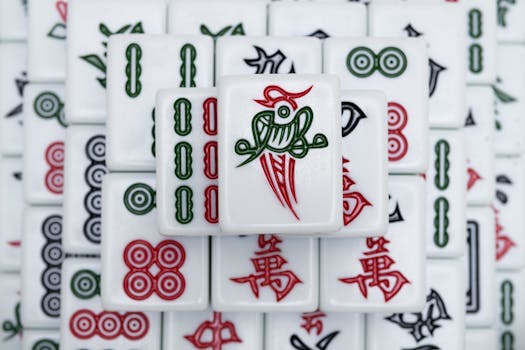 High angle view of decorative mahjong tiles intricately arranged, showcasing traditional symbols and colors.