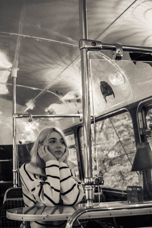 Grayscale Photo of Woman in Black and White Striped Jacket