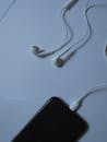 A Close-Up Shot of Wired Earphones Plugged in a Smartphone