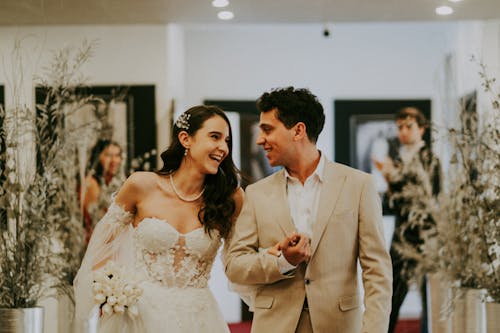 Bride and Groom Walking, Looking at Each Other and Smiling 