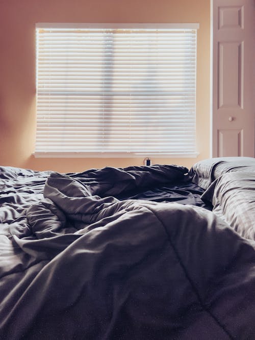 Empty Bed with Sheets in Home Bedroom