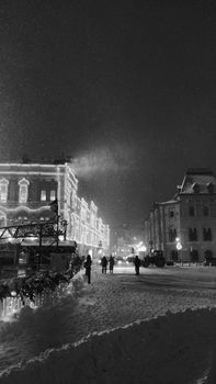 A snowy and illuminated night scene in Moscow, Russia, capturing the essence of winter in the city.