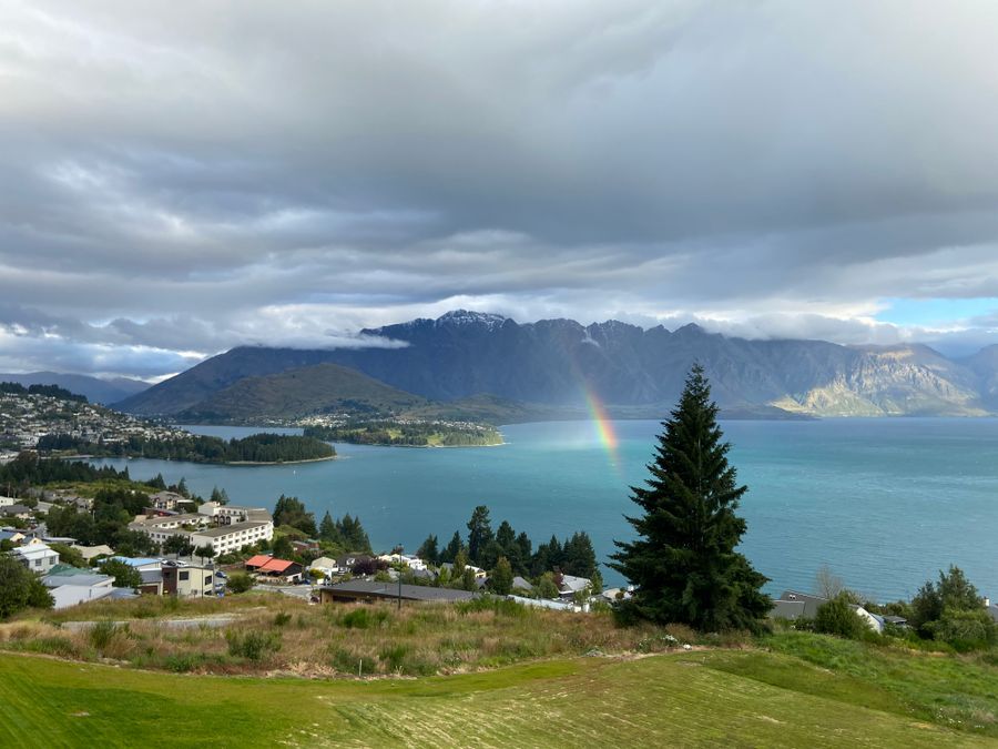 Rainbow over a lake and mountains seen from a stay