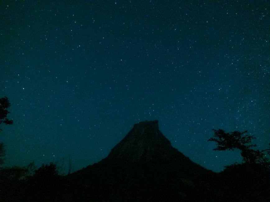Stunning view of the starry night sky with a silhouetted hill, perfect for nature and astronomy enthusiasts.