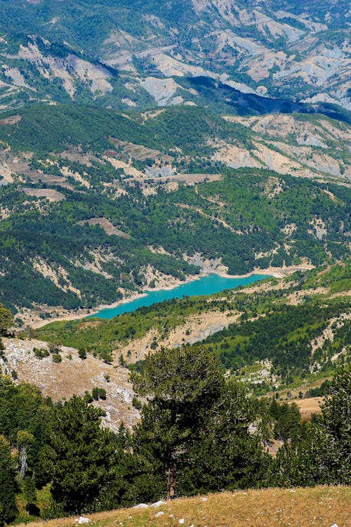 Aerial View of Mountains and a Blue Lake in a Valley 
