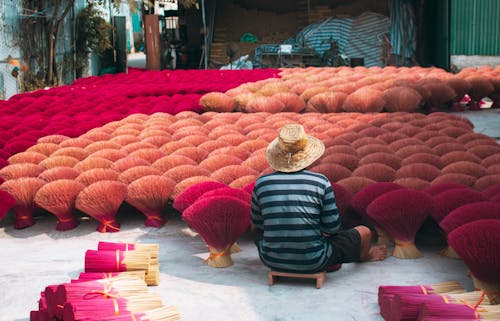 A Man Arranging Incense Sticks