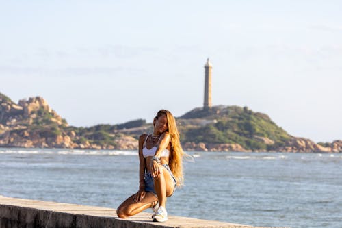 A Woman Posing with Long Hair Near the Sea
