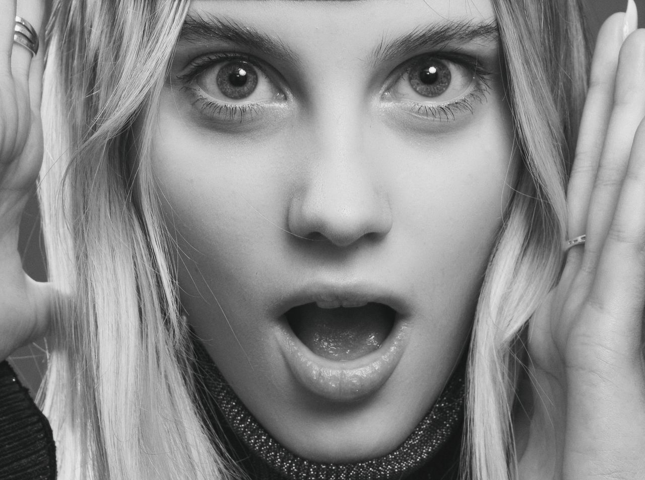 close up black and white portrait capturing a surprised expression of