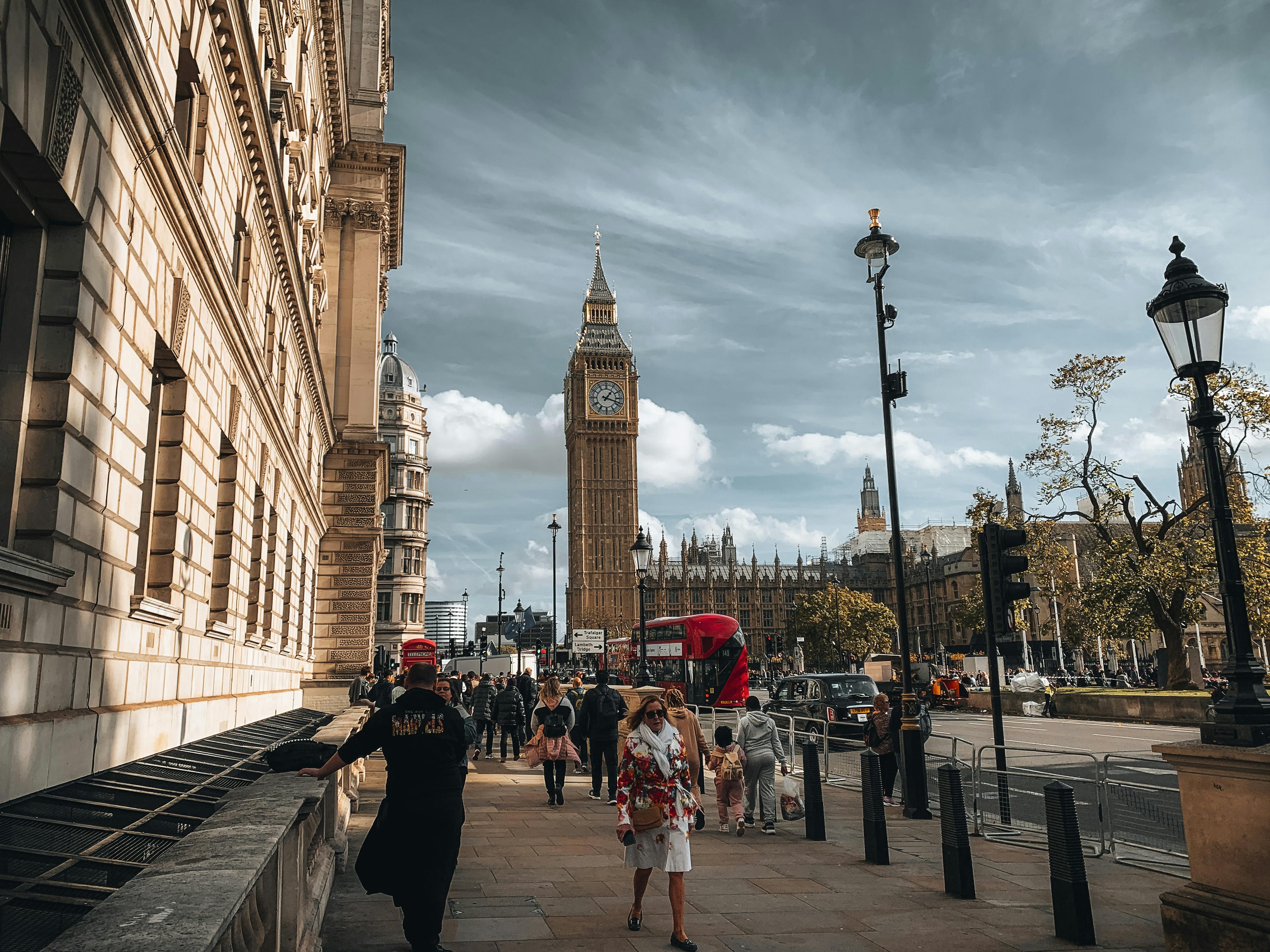 Captivating street scene in London showcasing Big Ben and bustling urban life on a sunny day.