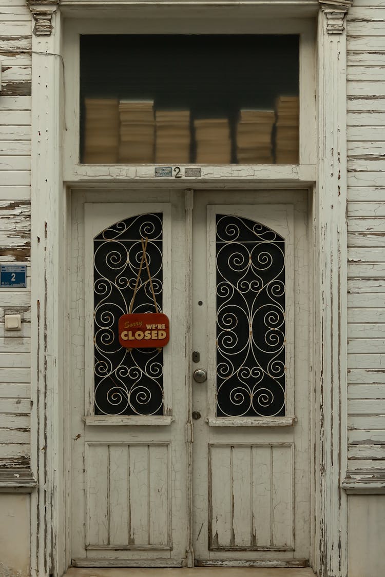 White Wooden Door With A Closed Signage