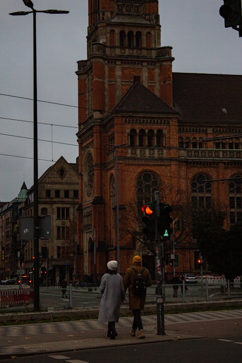 People Standing on Pedestrian Traffic Light in Front of Saint John s Church