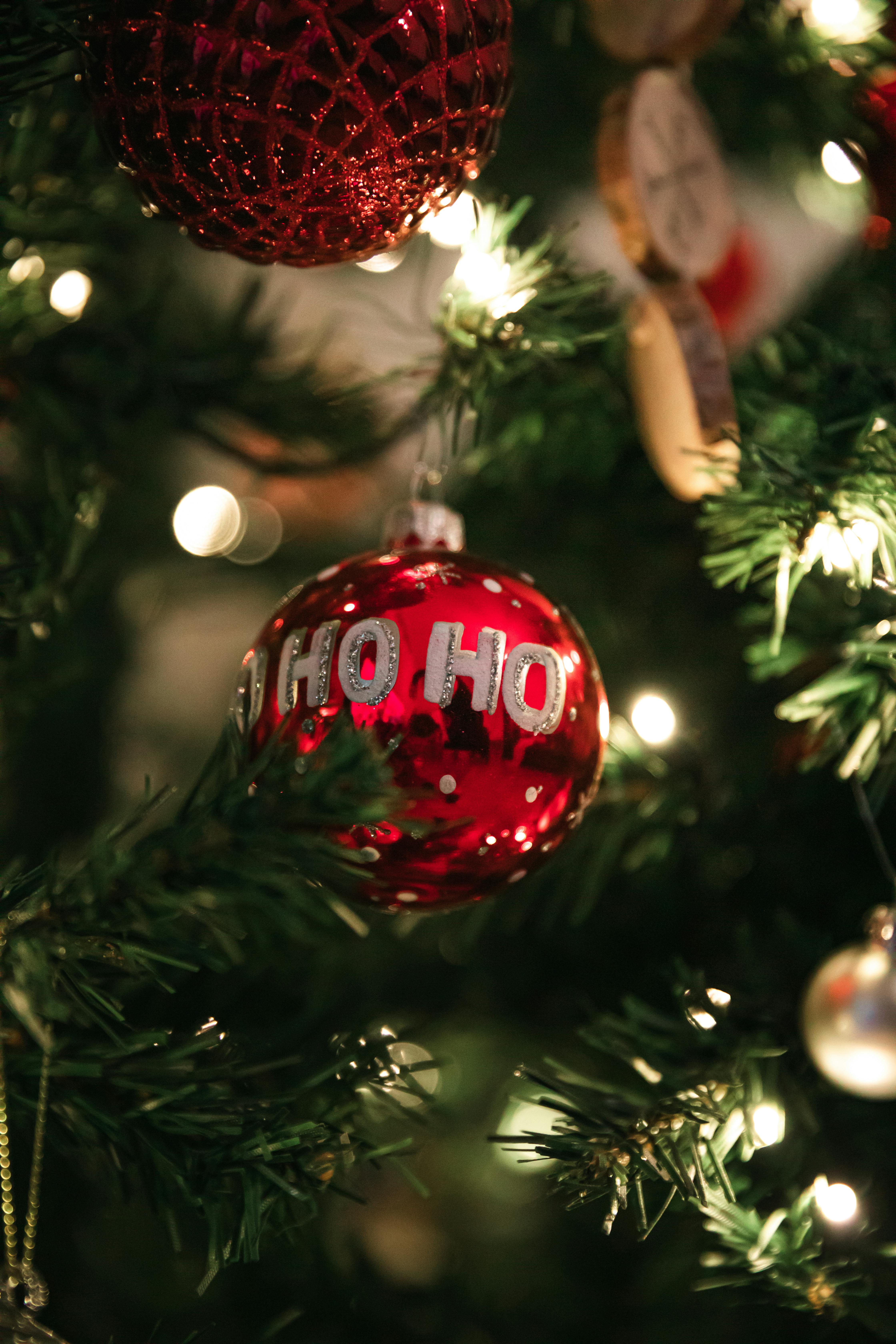 a christmas tree with ornaments and a red ball