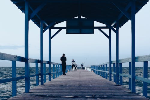 People fishing on a Wooden Jetty 