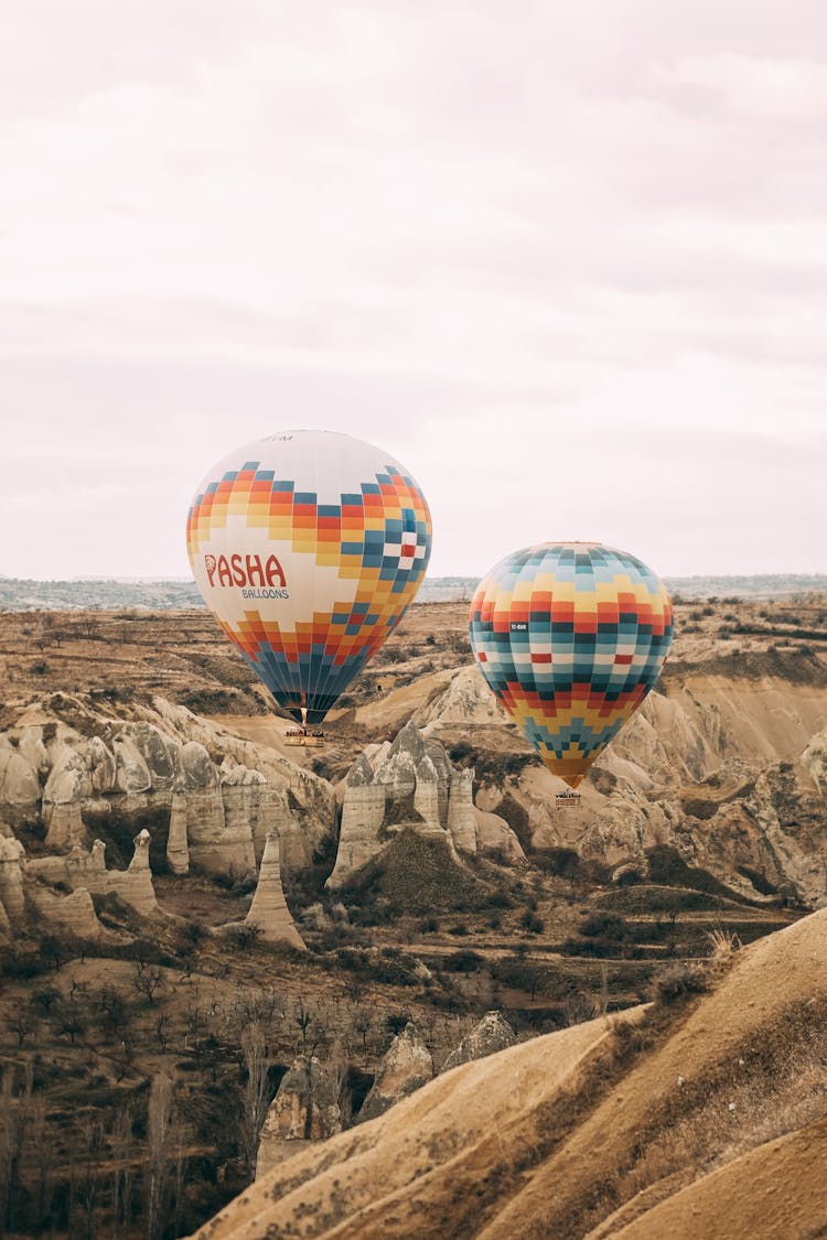 Balloons Flying Over Rocky Terrain