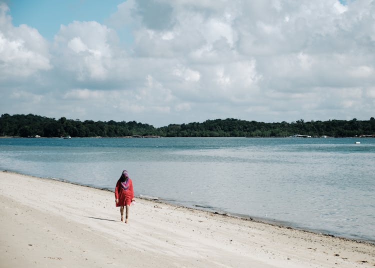 Woman Walking On Shore