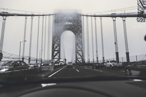 Grayscale Photography of Cars on Bridge