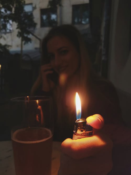 Woman Holding Lit Lighter