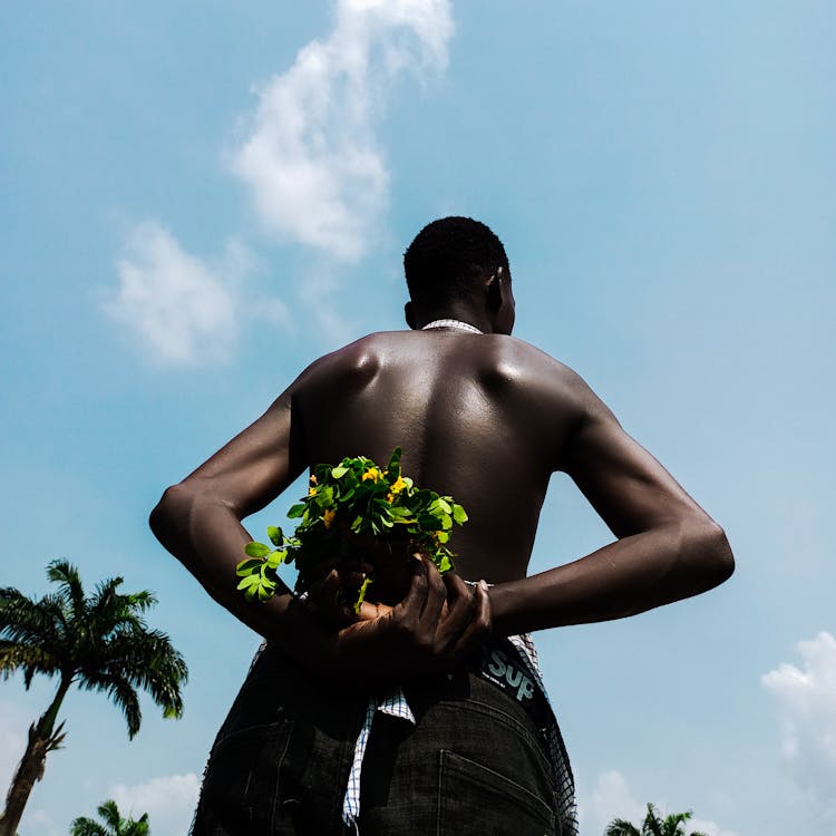 Shirtless Man Holding Flowers