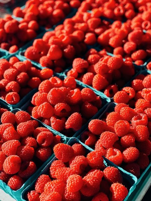 Bright and juicy fresh raspberries on display at a market in Toronto, Canada.