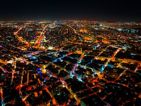 Breathtaking aerial view of a city's illuminated urban landscape at night.