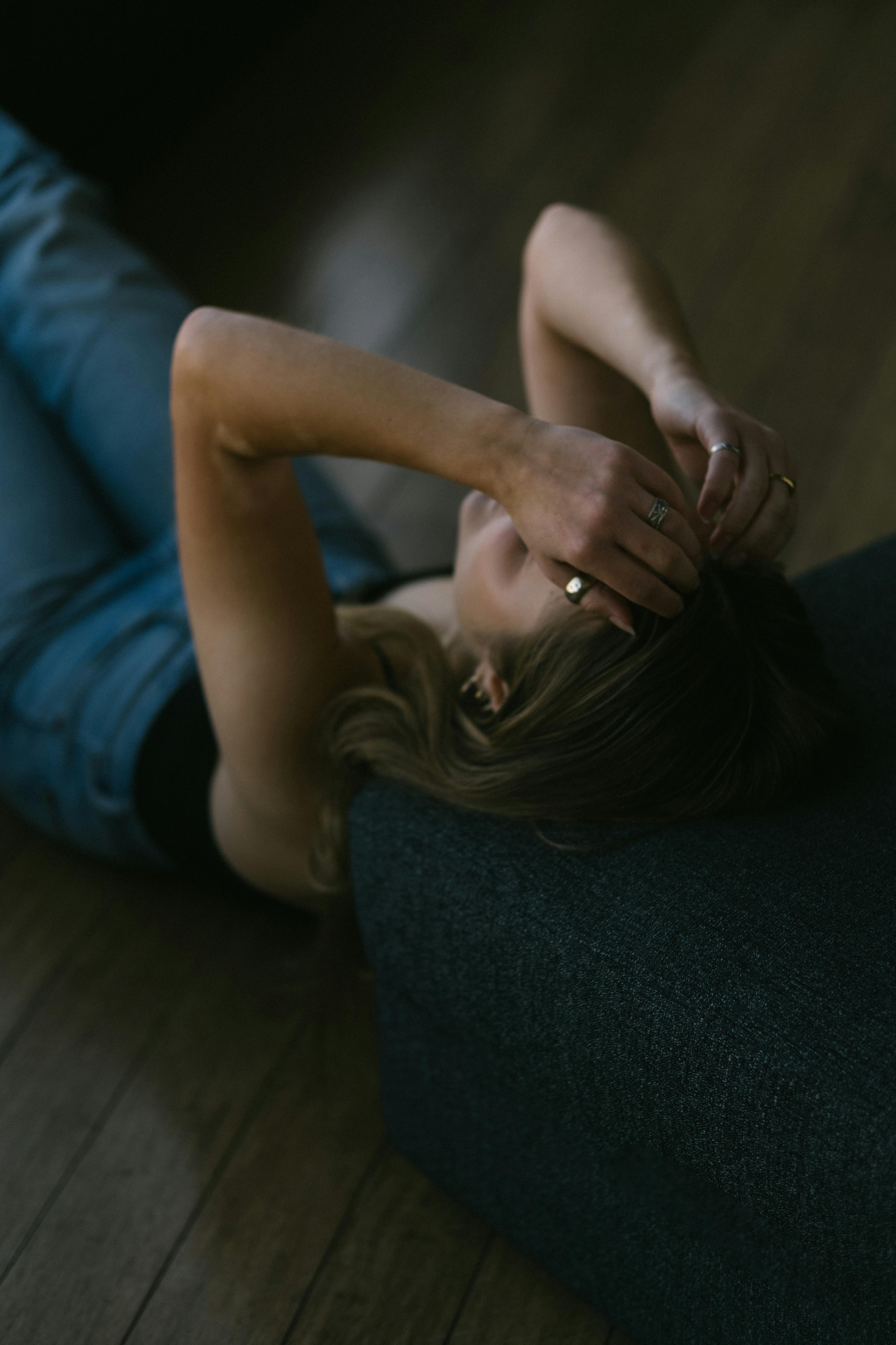 A Woman Lying Down on the Floor Looking Depressed · Free Stock Photo