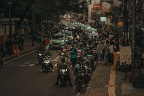 Free A bustling street in Jakarta filled with motorbikes and people on a busy day. Stock Photo