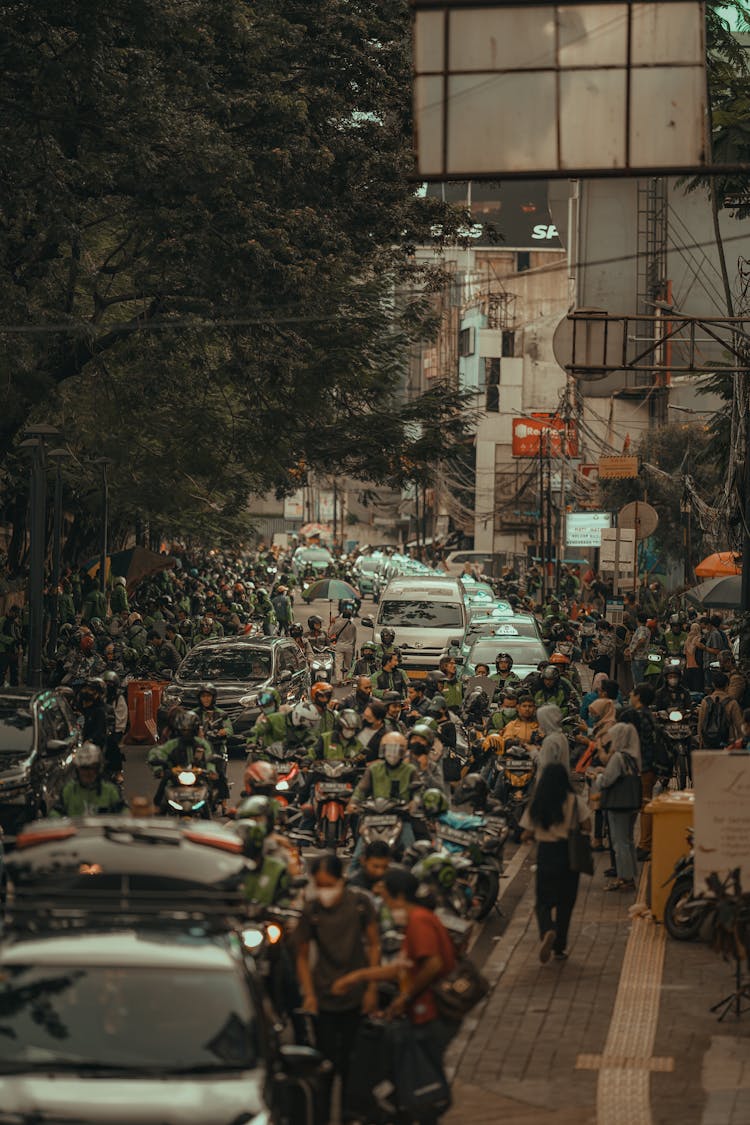 A Busy Road With Crowded People And Vehicles