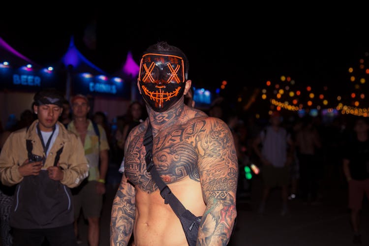 A Shirtless Man Wearing A Mask 