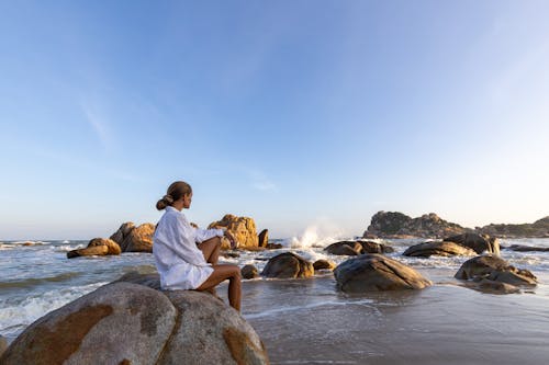 Free A Woman Sitting on the Rock  Stock Photo