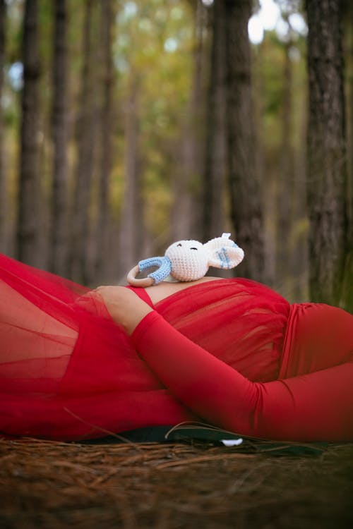 A Pregnant Woman Lying in a Forest 