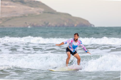 Photograph of a Man Surfing