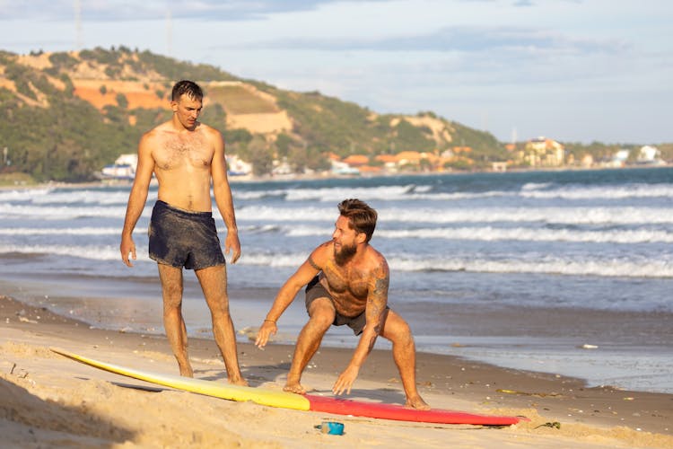 A Man Learning How To Surf 