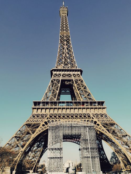 Free A stunning view of the iconic Eiffel Tower against a clear blue sky in Paris. Stock Photo