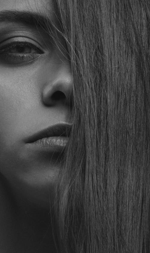 Grayscale Photo of Woman Covering Her Face With Hair