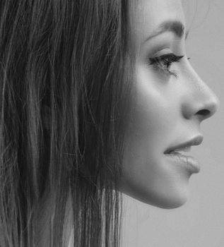Elegant monochrome profile of a woman with smooth skin and captivating eyes.