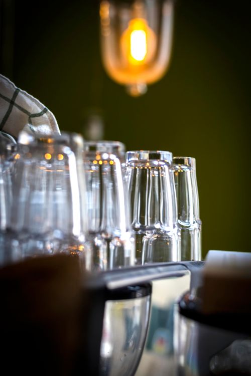 Free Close-up of stacked glasses with warm ambient lighting creating a cozy atmosphere. Stock Photo