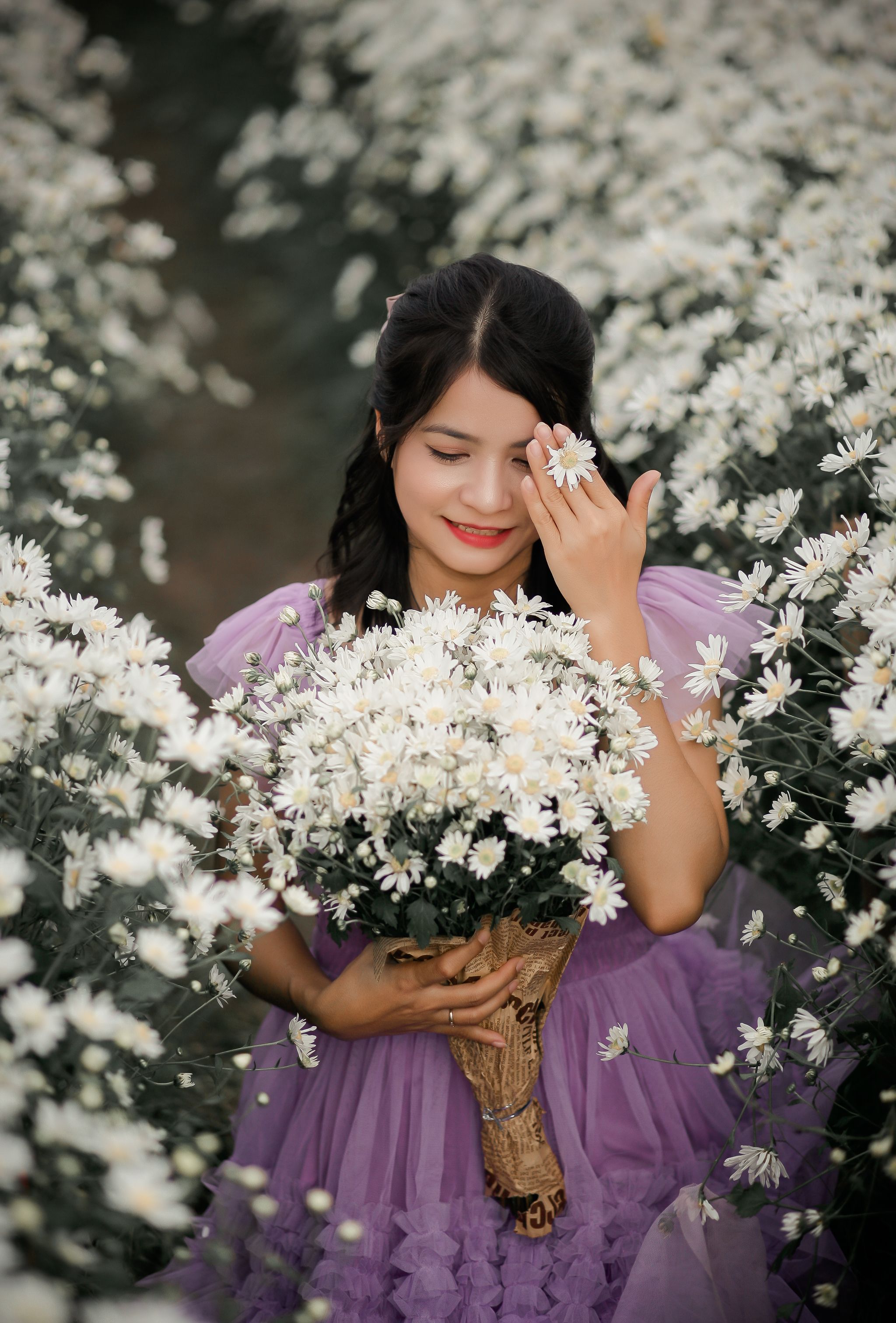 Young Woman Smiling in Purple Dress Holding a Bouquet of Flowers · Free ...
