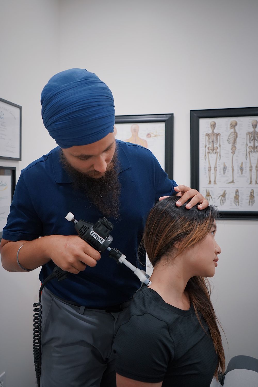 Chiropractor performing a neck adjustment in a clinical setting
